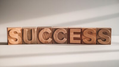 Wooden cubes forming the word 'success'